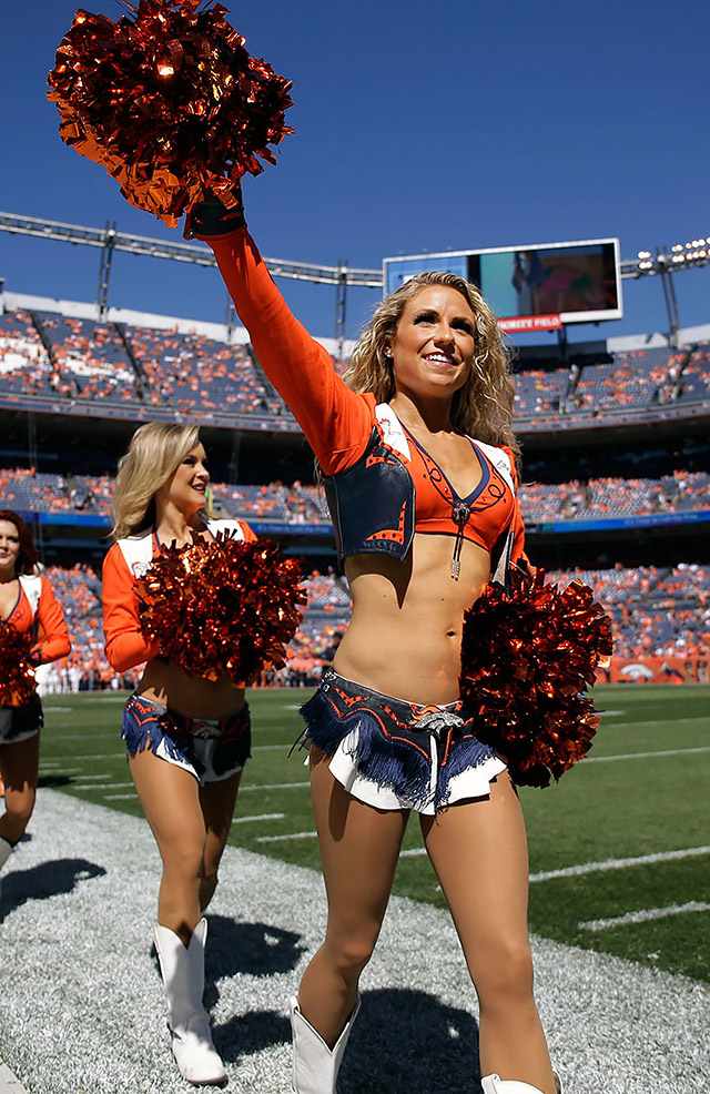 A Denver Broncos cheerleader waves to the crowd during the first half in a NFL football game between the Denver Broncos and the Indianapolis Colts, Sunday, Sept. 18, 2016, in Denver. (AP Photo/Jack Dempsey)